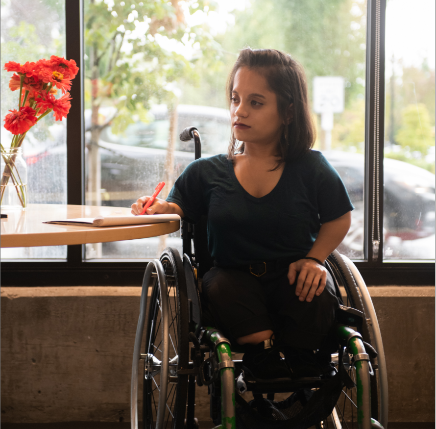 Lady in a wheel chair at a table