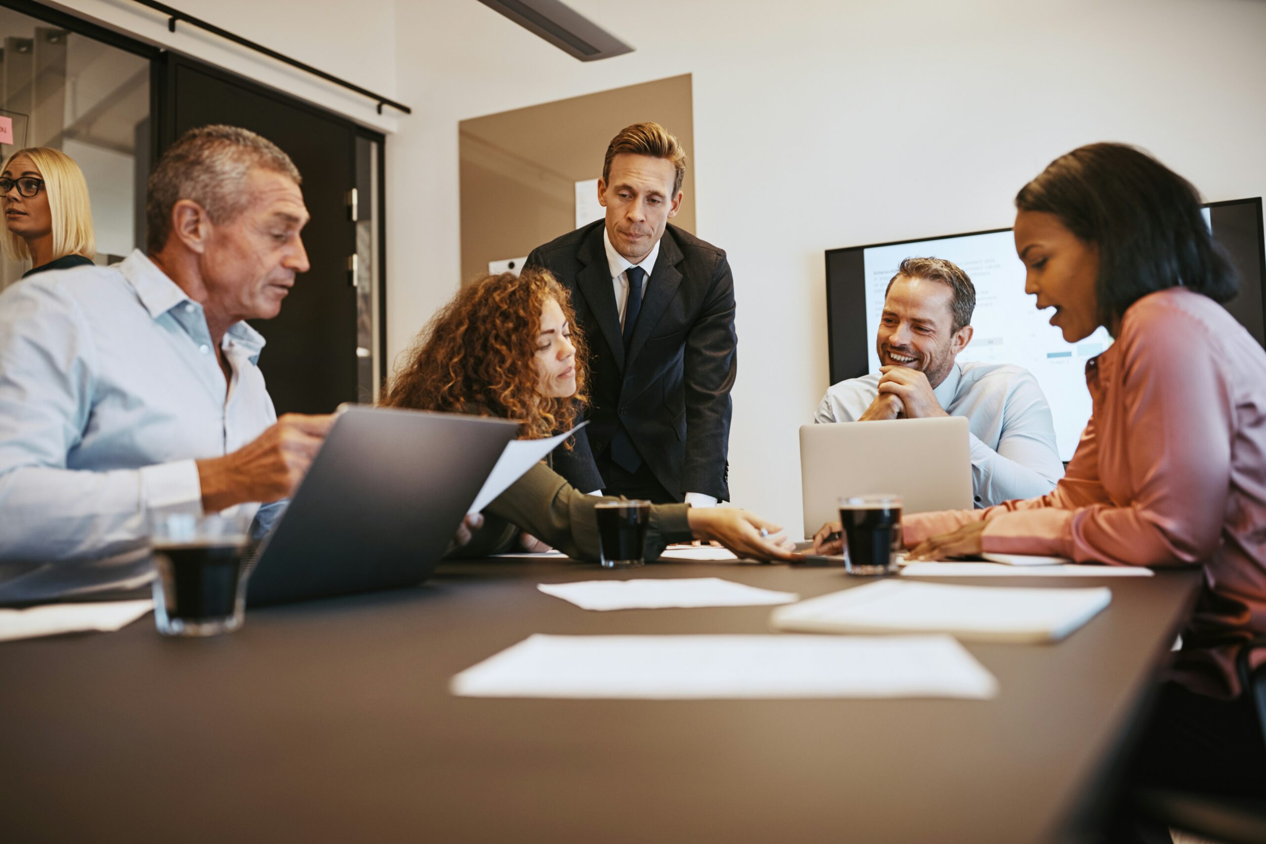 People sat round a boardroom table working together