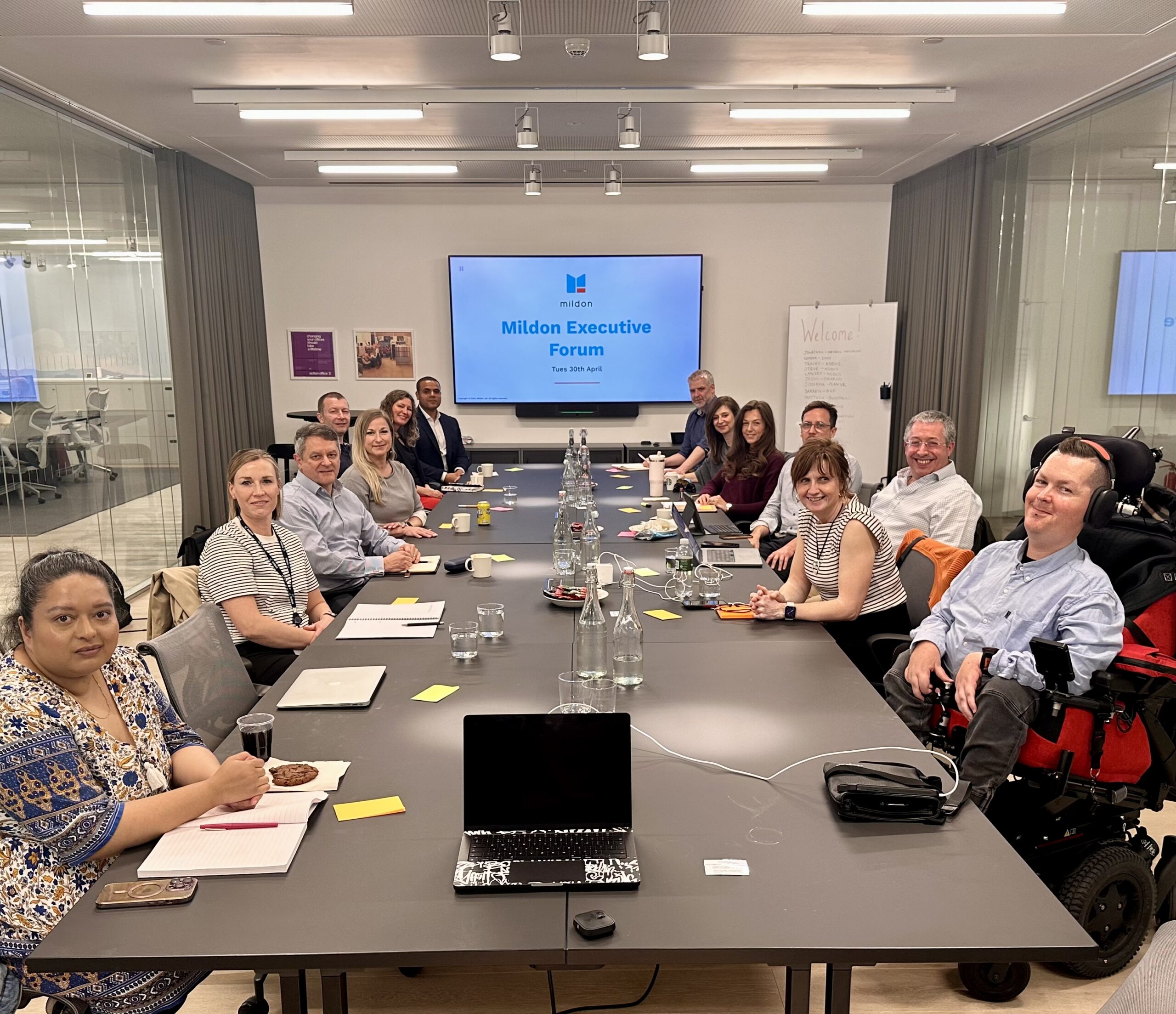 Photo of people sat around the boardroom table